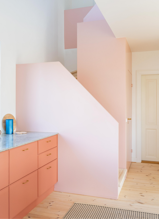 Lyserødt køkken med messingdetaljer