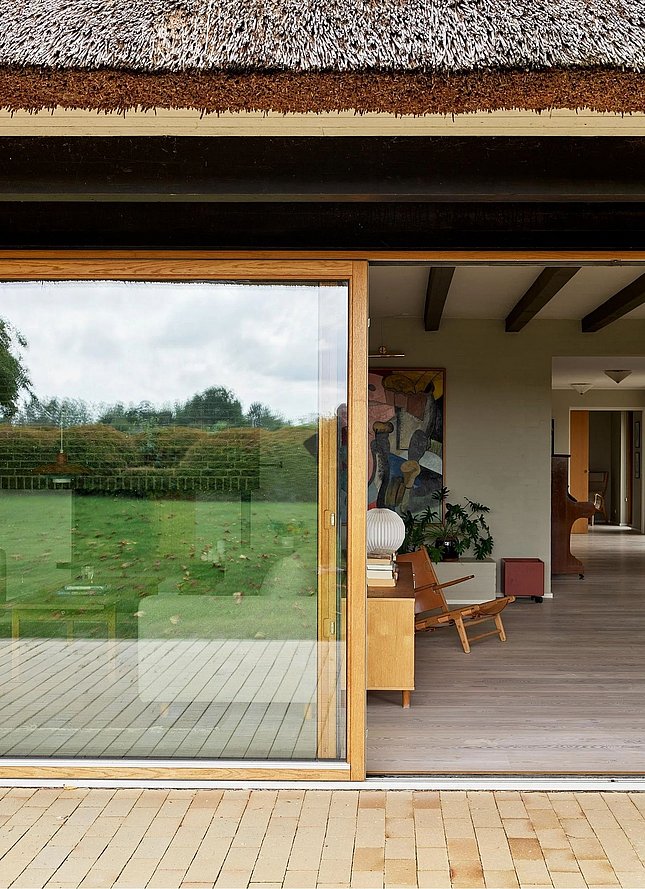 Renoveret landvilla med store skydedøre af glas