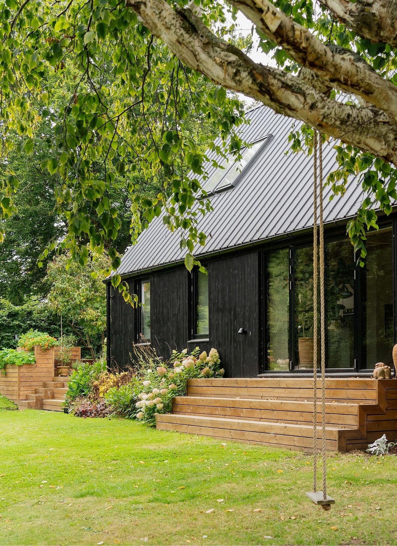 Moderne tilbygning i sort træ til parcelhus fra 60'erne